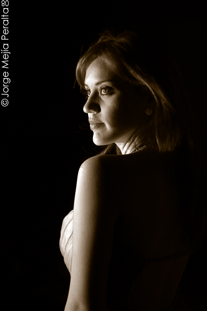 a woman looking off into the distance with black background