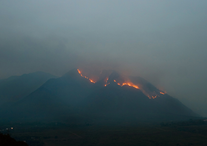 large mountains with flames coming from them, in the distance