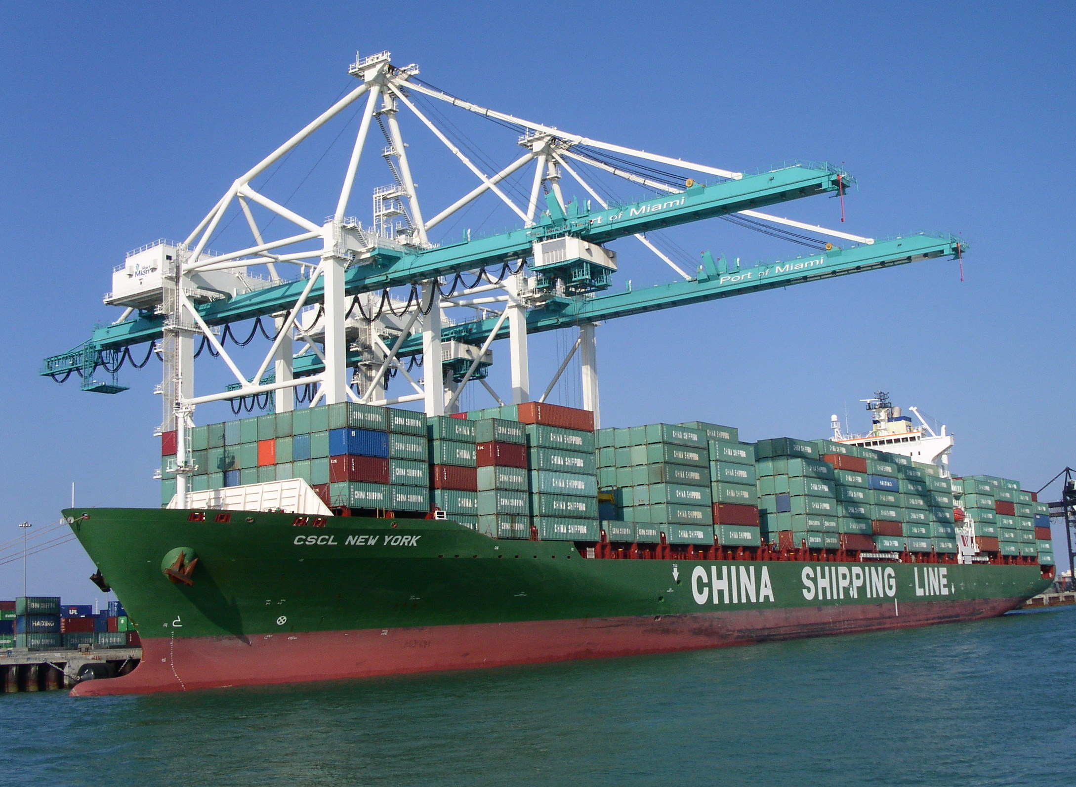 a large cargo ship in the water with containers stacked on it