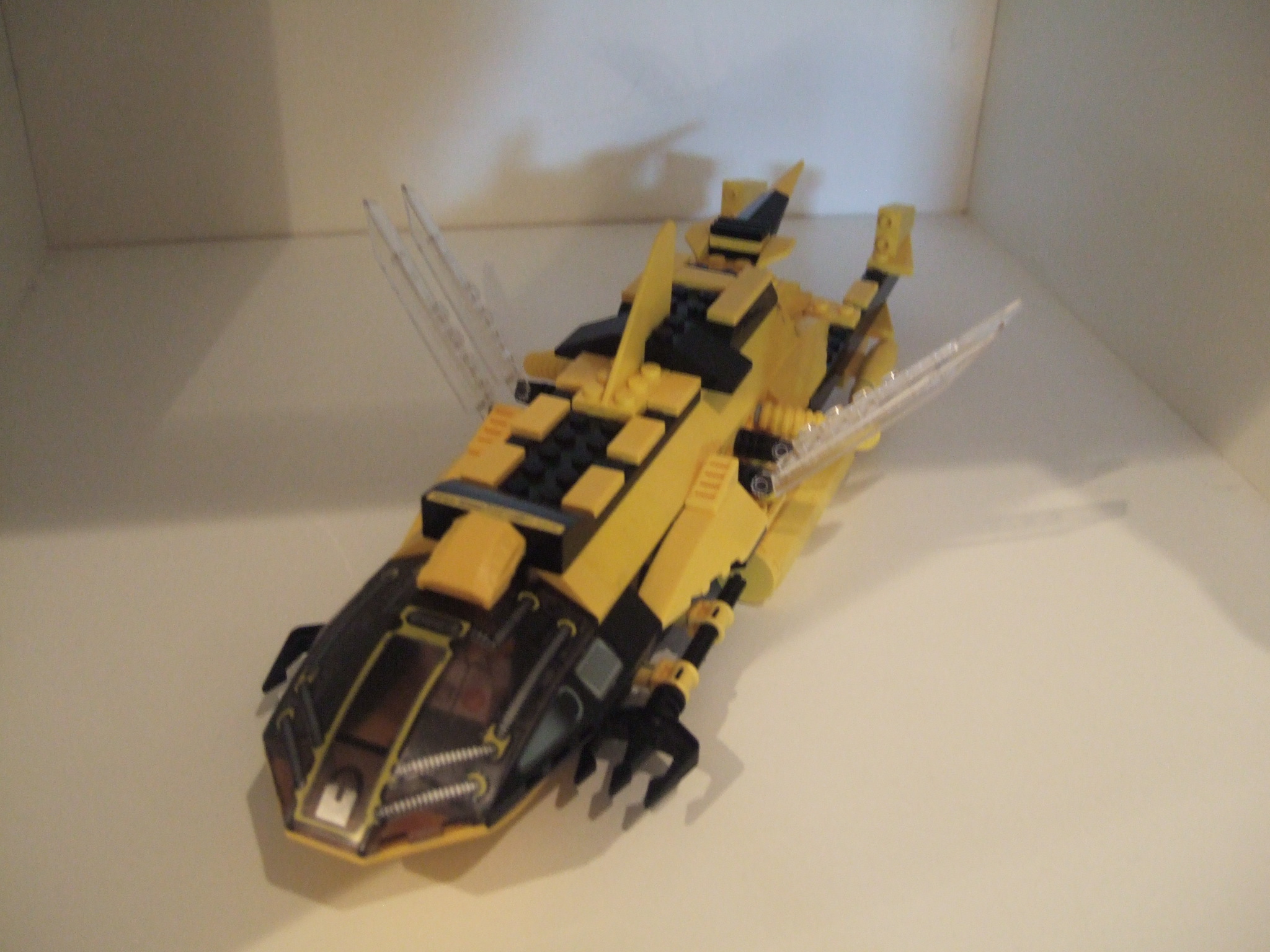 a lego yellow and black vehicle on display