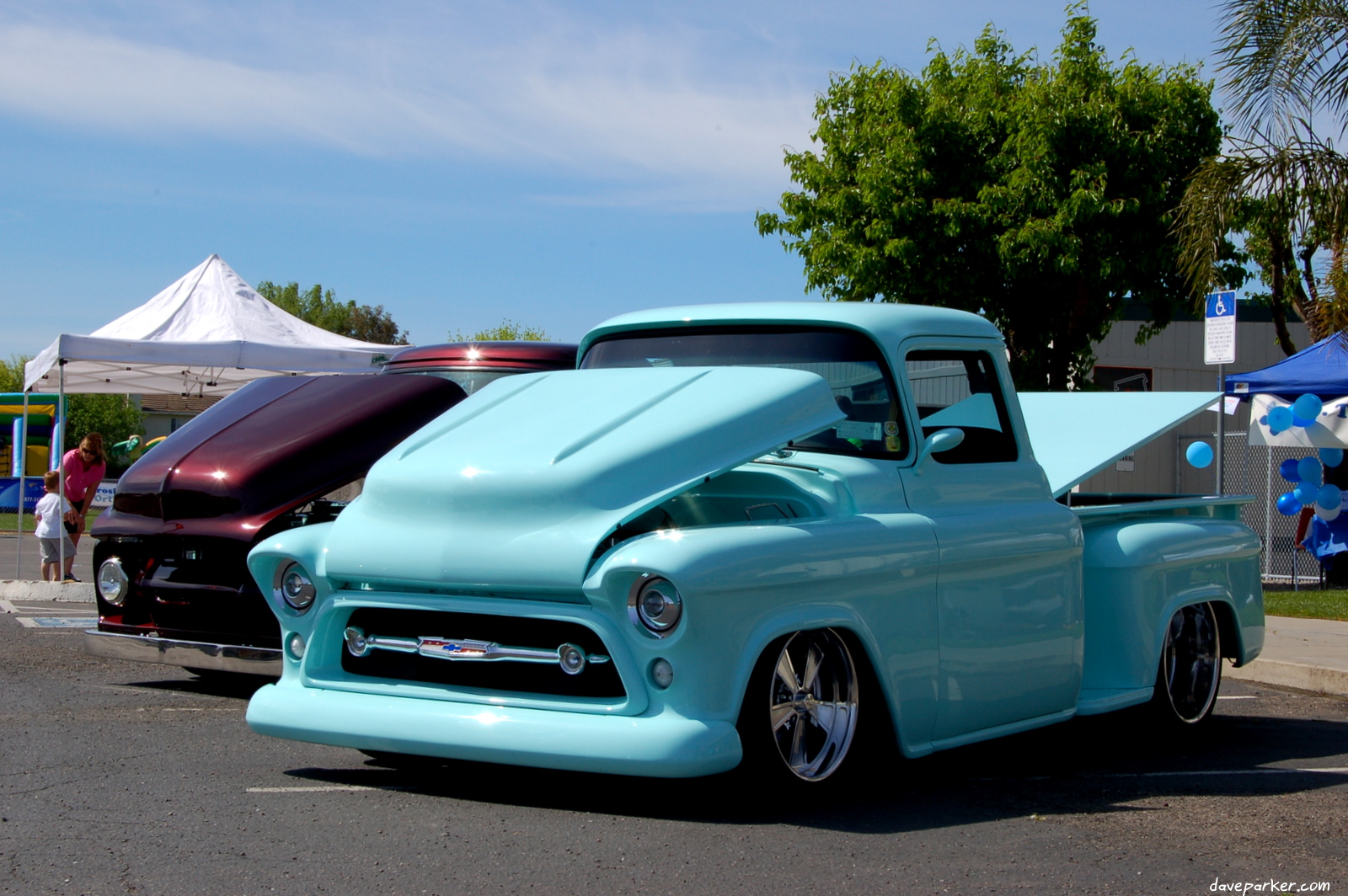 a blue pick up truck parked next to a white tent