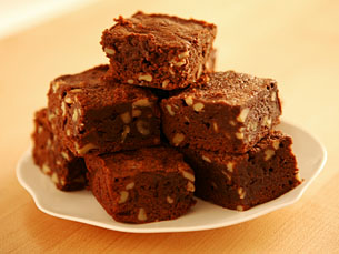 small brownies sitting on top of a white plate
