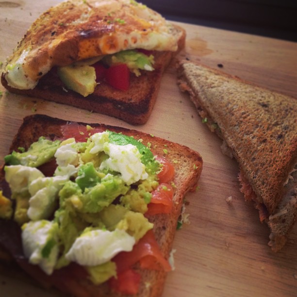 some toasted sandwiches with guacamole on top