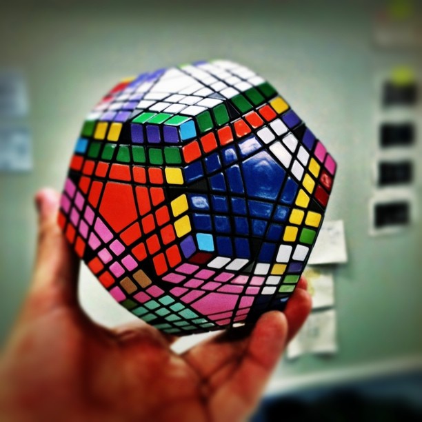 someone is holding a colorful ball with lots of colors