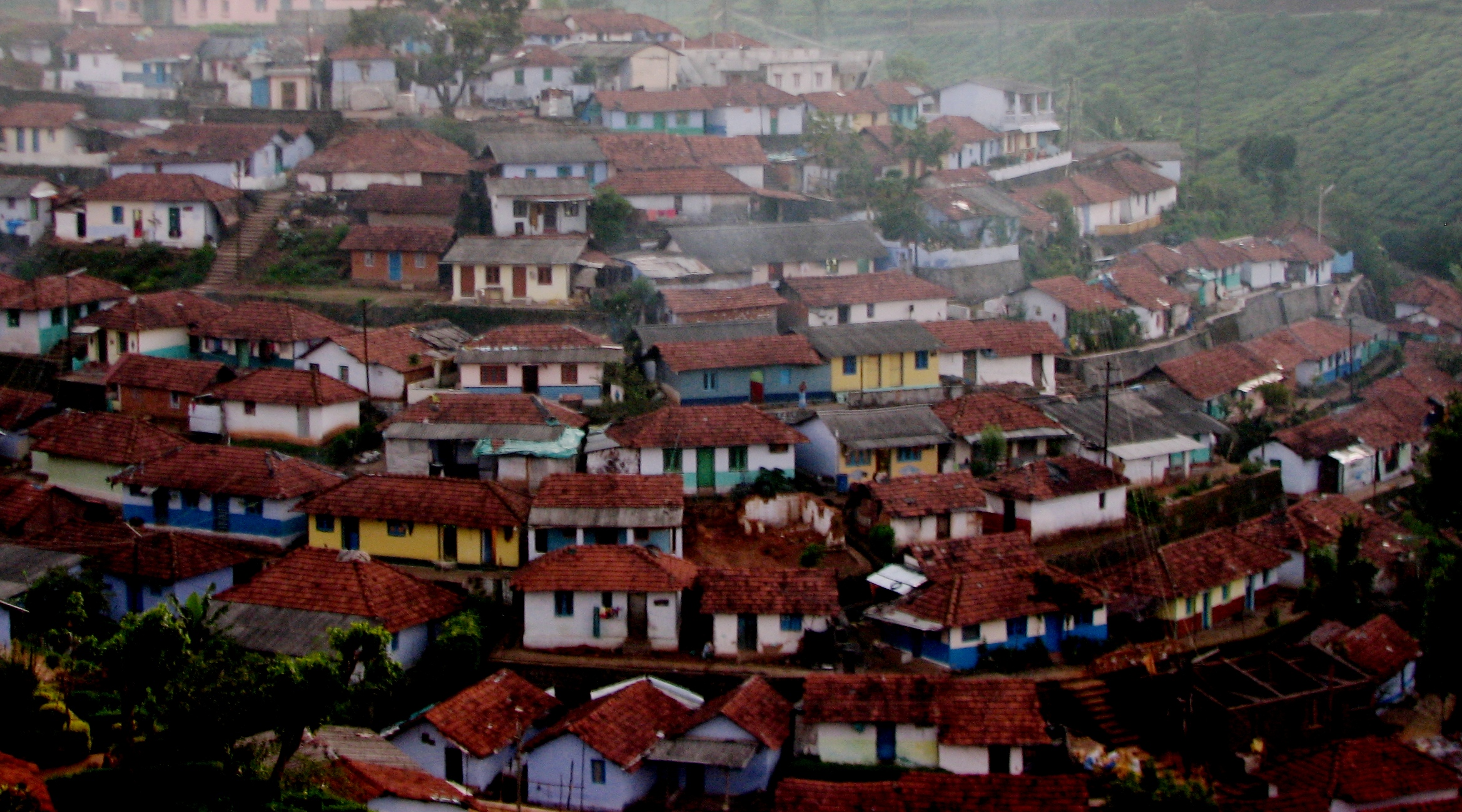 a city filled with small houses covered in lots of rain