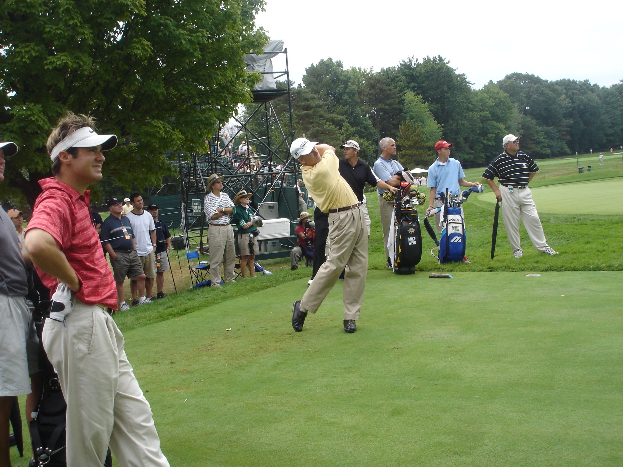 a group of people playing golf in a green field