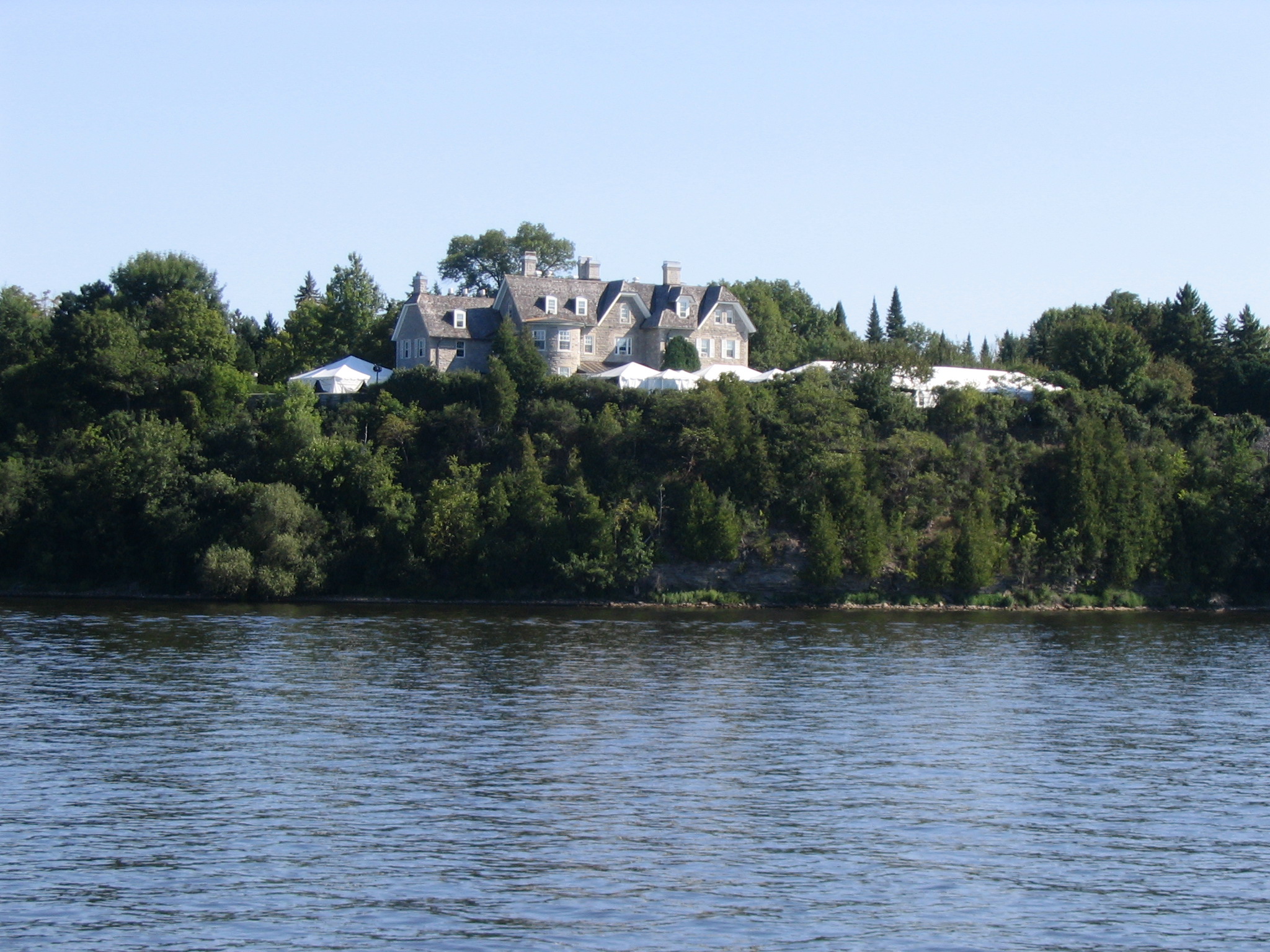 a castle sitting on a mountain with trees around it