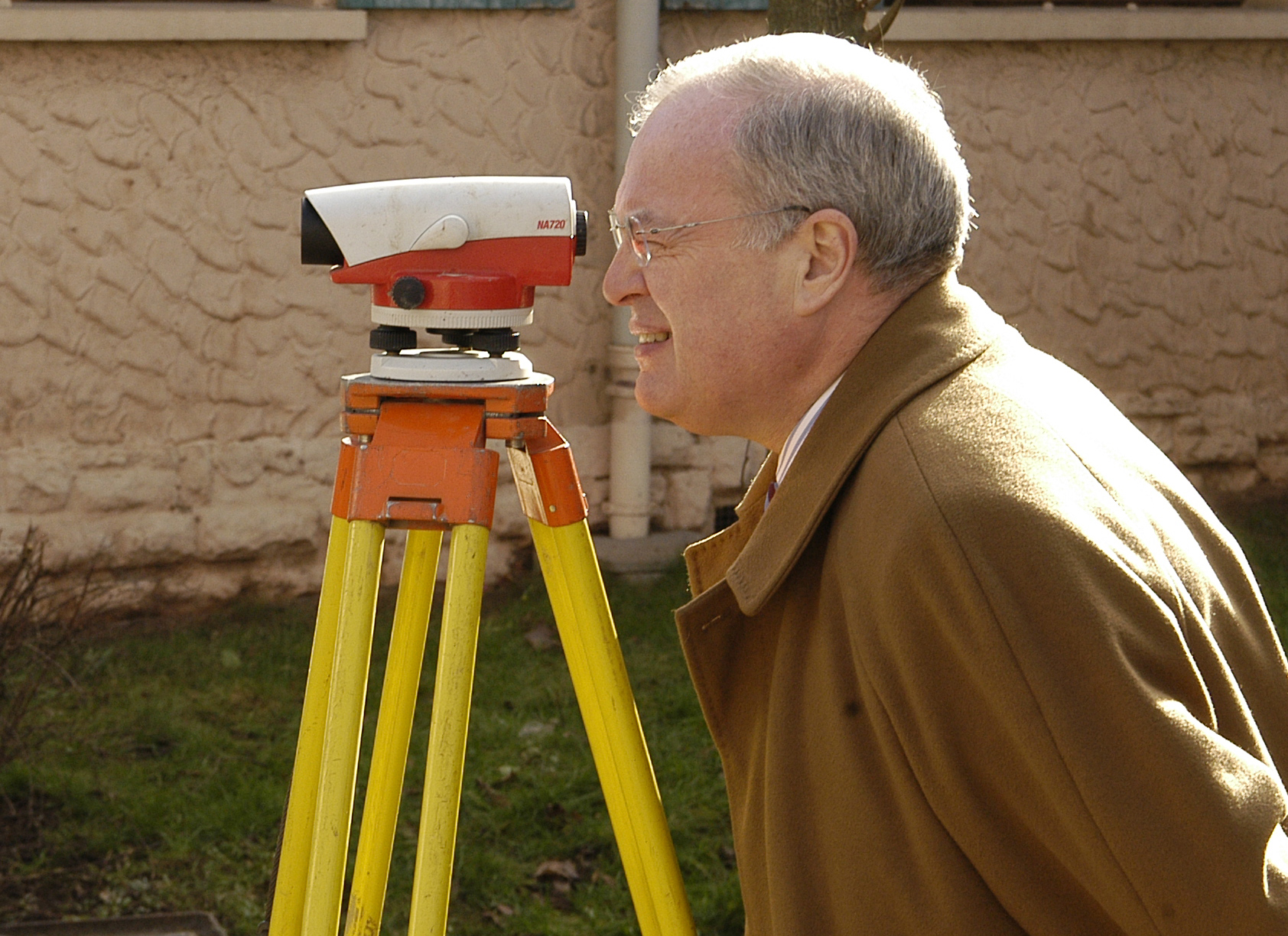 an older man looking through a telescope into the air