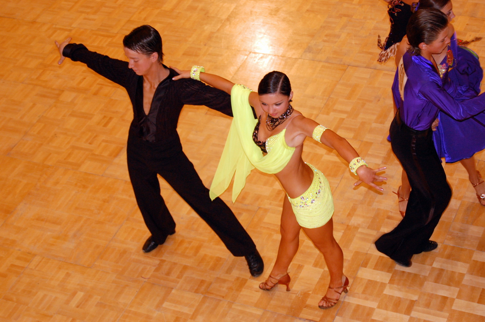 two dancers are performing on the dance floor in bright yellow