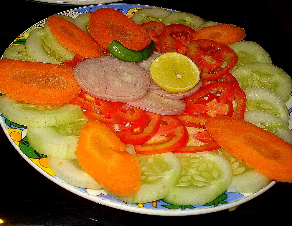 a plate that has some sliced vegetables on it