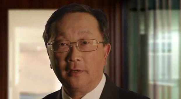 an asian businessman wearing a suit and tie