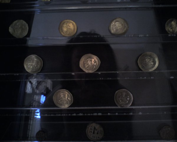 a black glass case holds coins on it