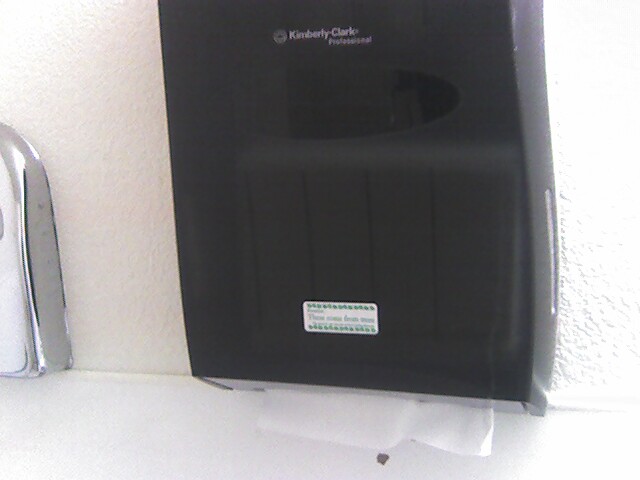 there is a hand towel dispenser next to a paper towel dispenser