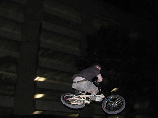 a man is on top of a bike doing tricks