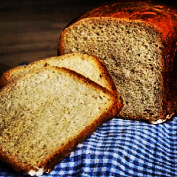 several slices of fresh bread sitting on top of a checkered cloth