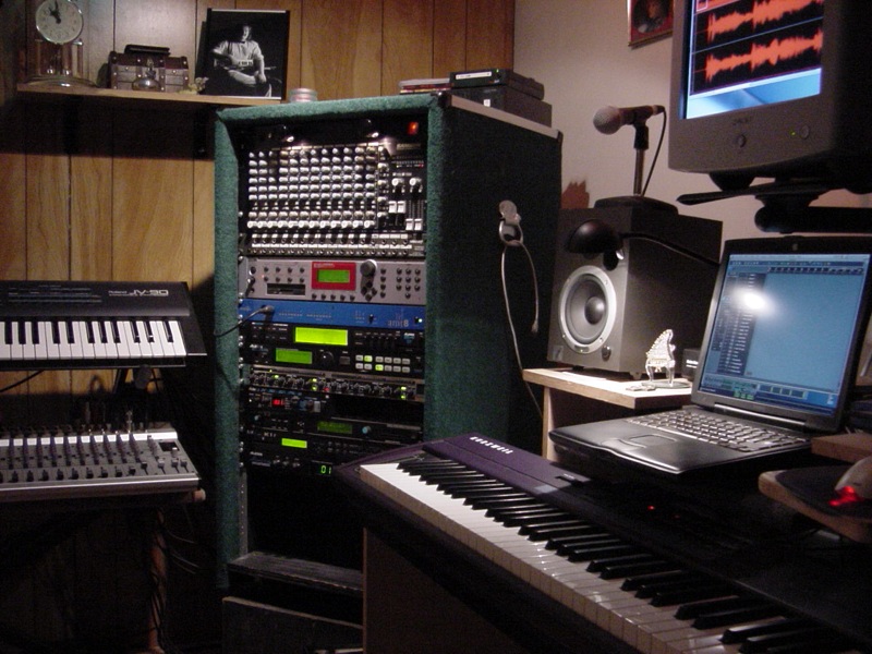 two audio mixing consoles, several keyboards and other musical equipment