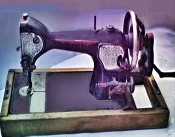 a old sewing machine on a wooden base