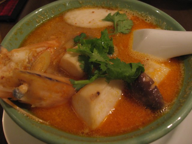 a close up of a bowl of soup with a spoon