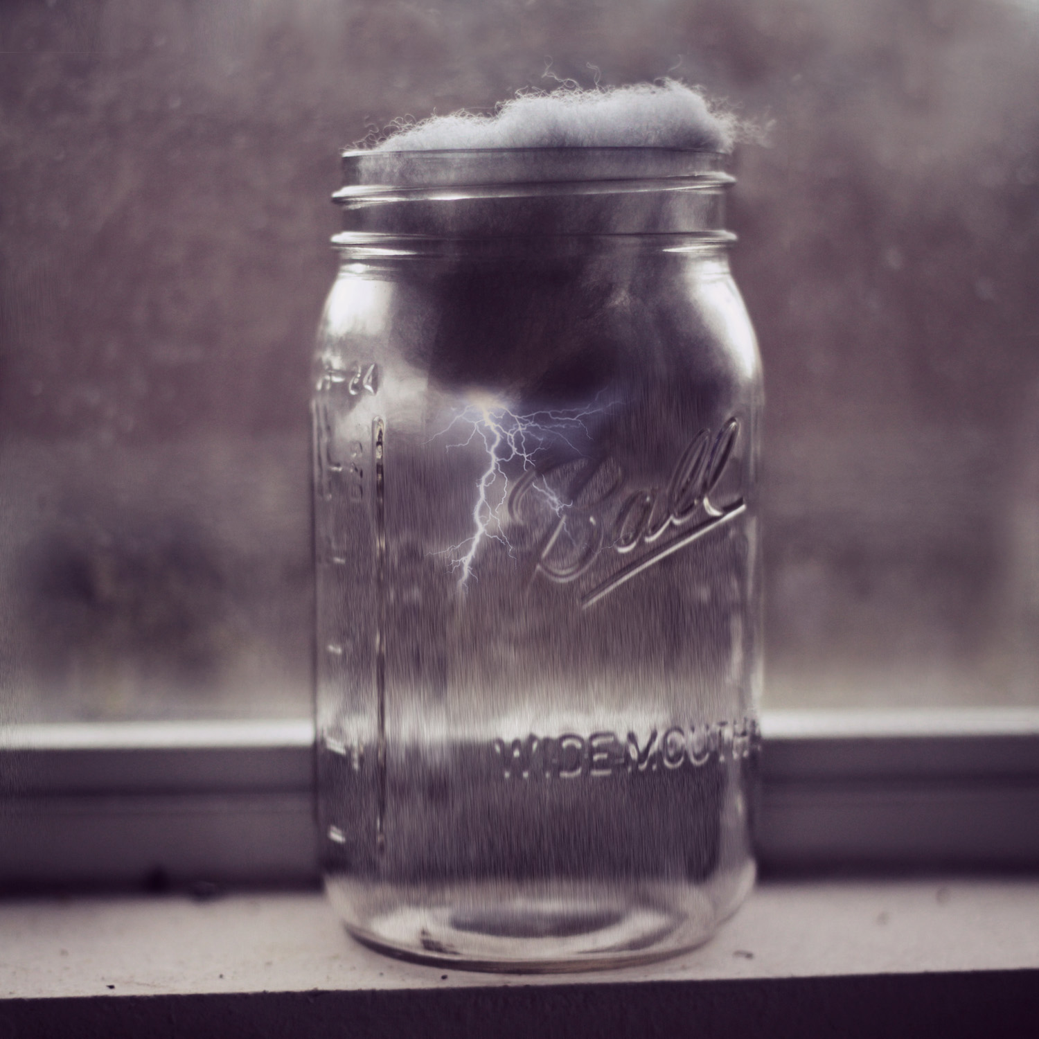 the old mason jar is on the window sill