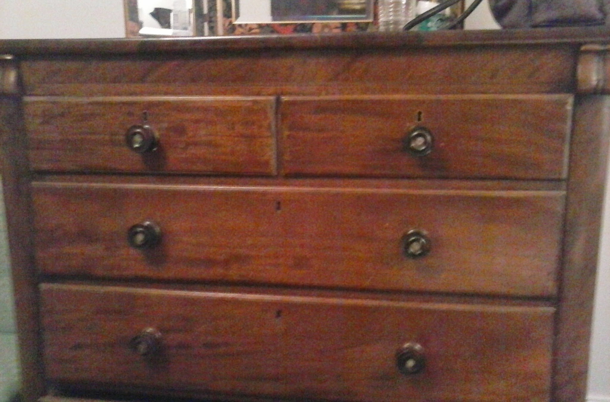 an old chest of drawers has been repaired