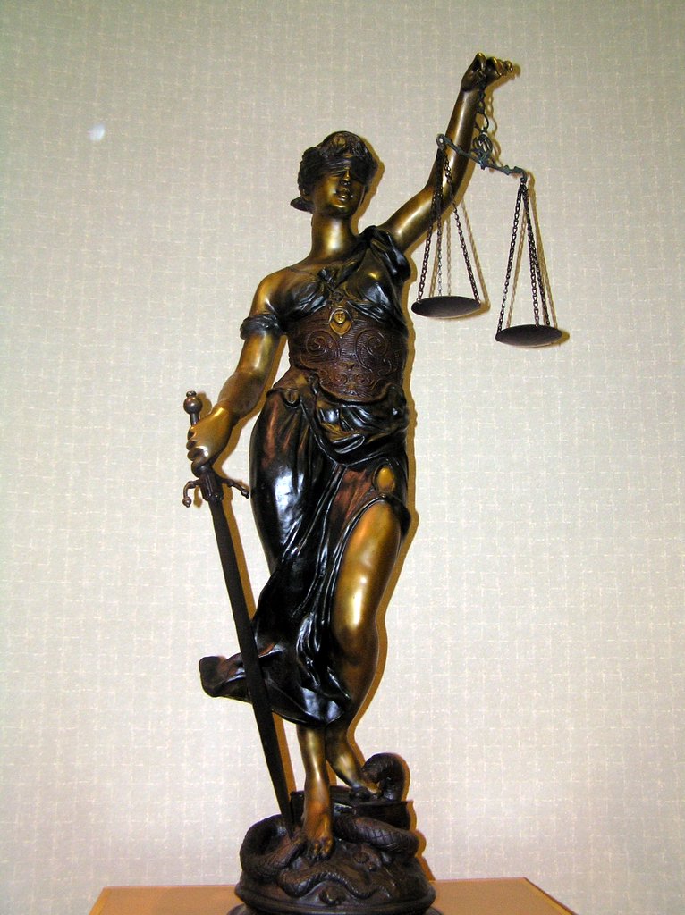 a statue of lady justice with an scale and a sword