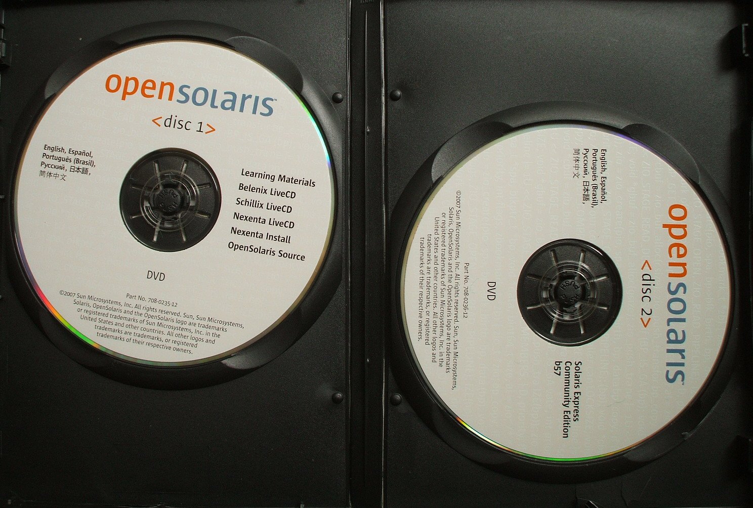 two dvd cases, one of which contains an open sign and the other has an open sign