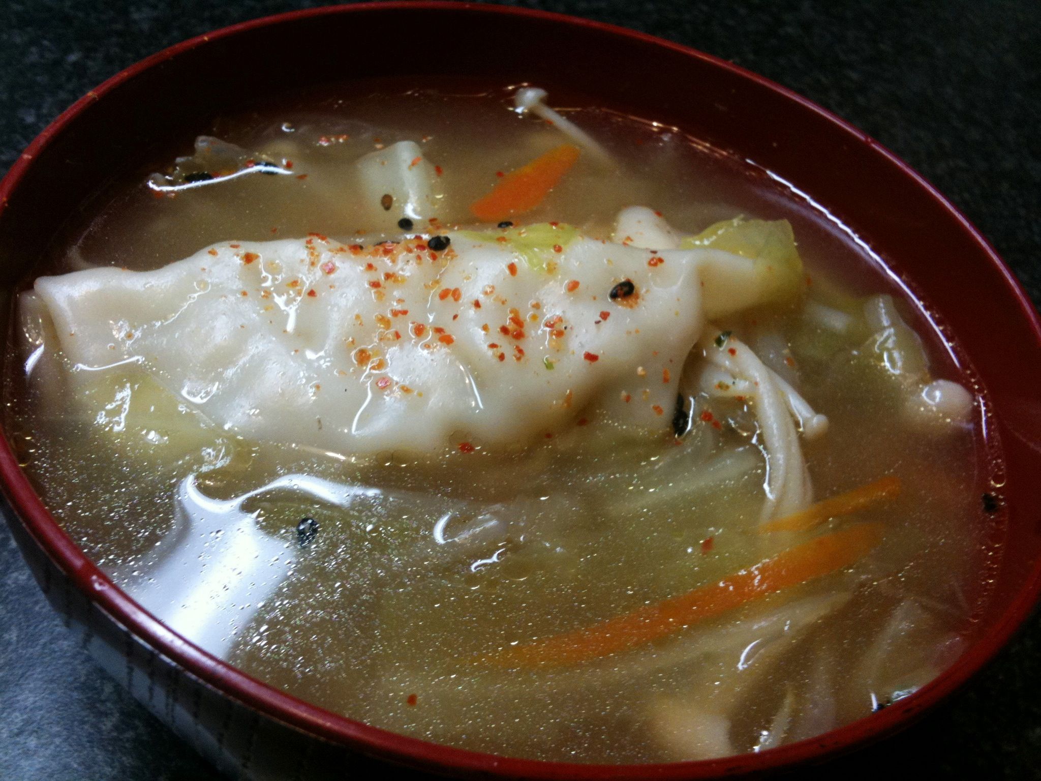 this soup features dumplings, noodles, and carrots