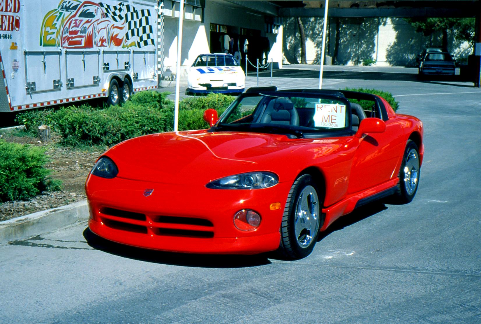 a red sports car sitting on the street