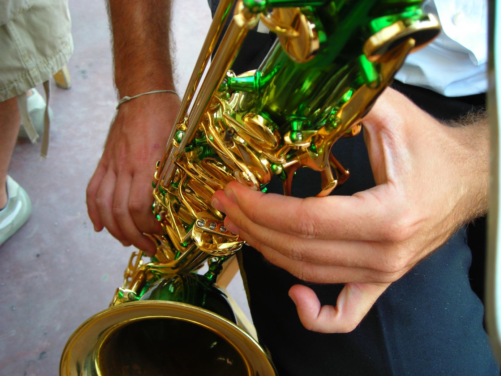a musician playing a gold instrument at a wedding