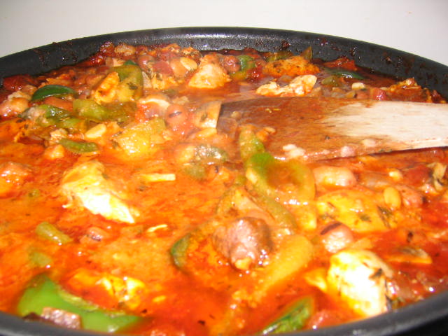 there is a red stew with meat and vegetables