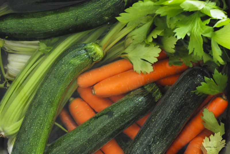 many carrots and zucchini are displayed together