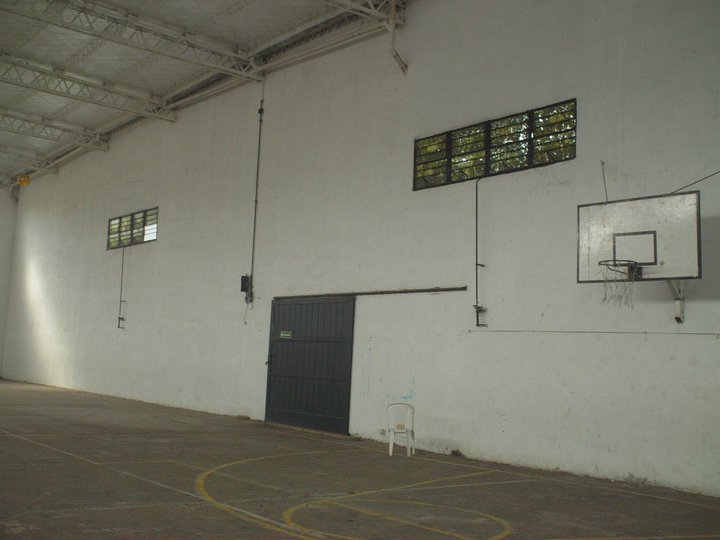 an empty building has basketball hoops hanging from the ceiling