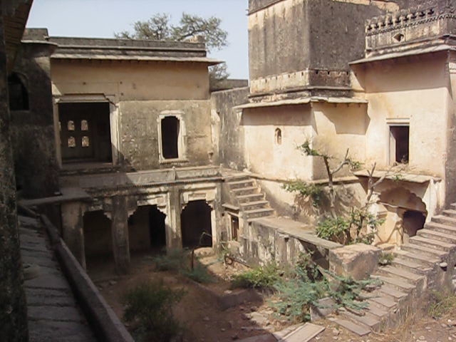 view of the ruins of an old building looking out over an old courtyard