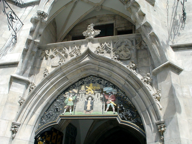 a building with a very elaborate stone arch and clock above