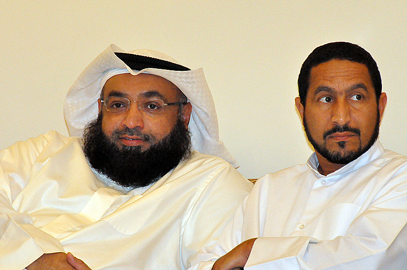 two arabic men with beards on sitting next to each other
