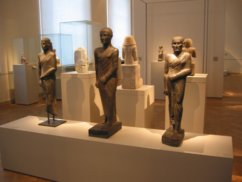 a museum area filled with various statues of people