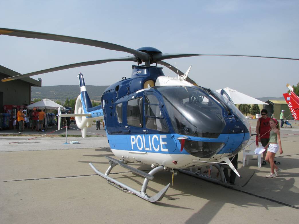 a police helicopter parked at an airport