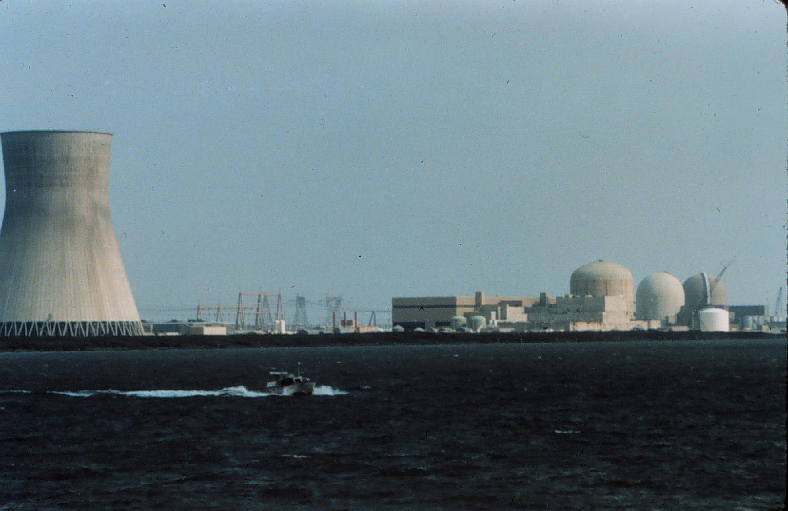 a jetliner flying low by a nuclear power plant