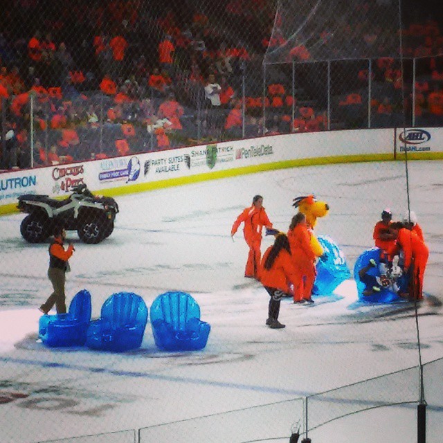 some orange and black colored sports teams on an ice rink