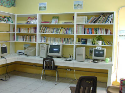 a room with bookshelves filled with computer screens