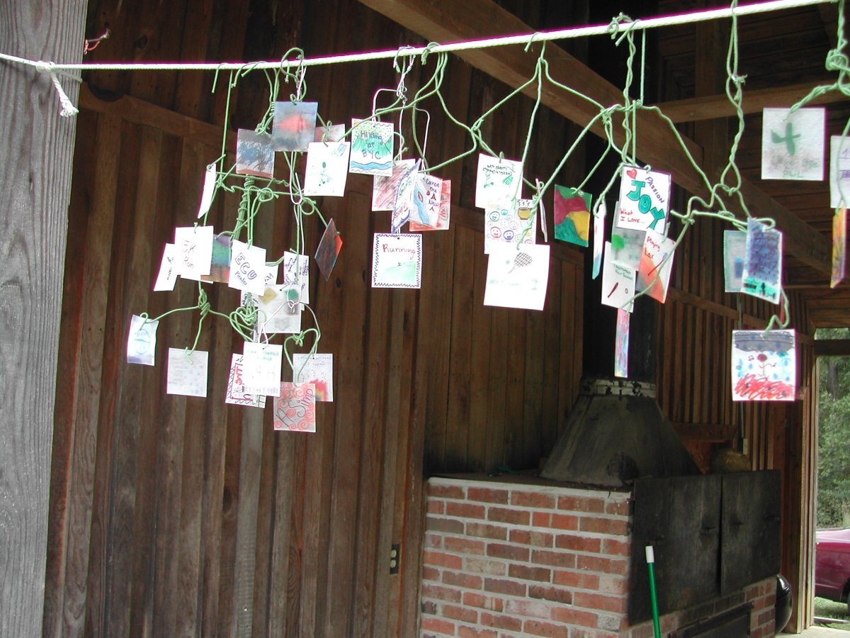 a group of cards hanging from clothes pins on a wire
