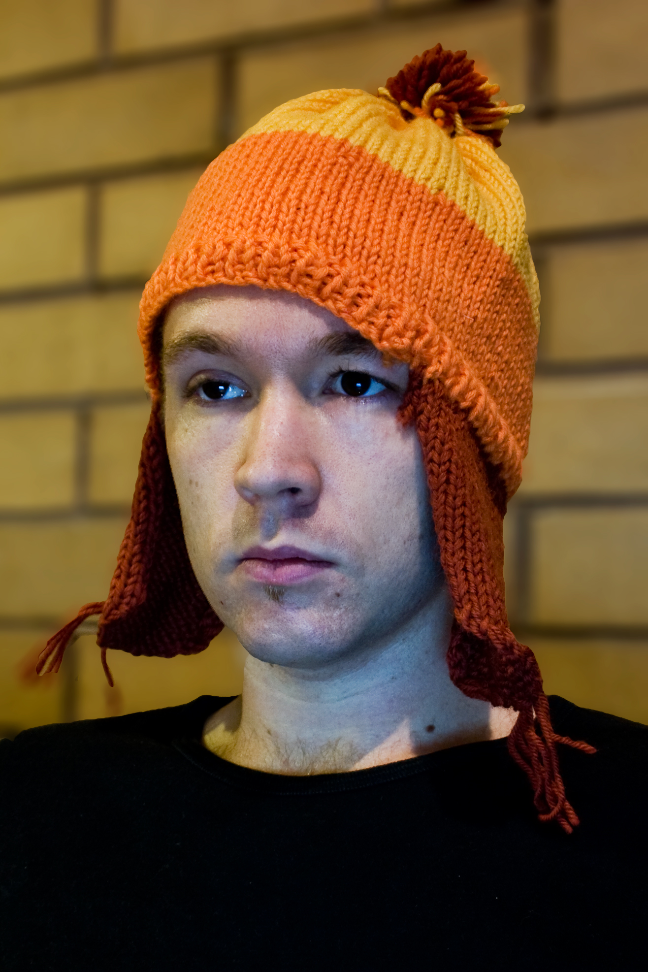man wearing orange and yellow knitted hat