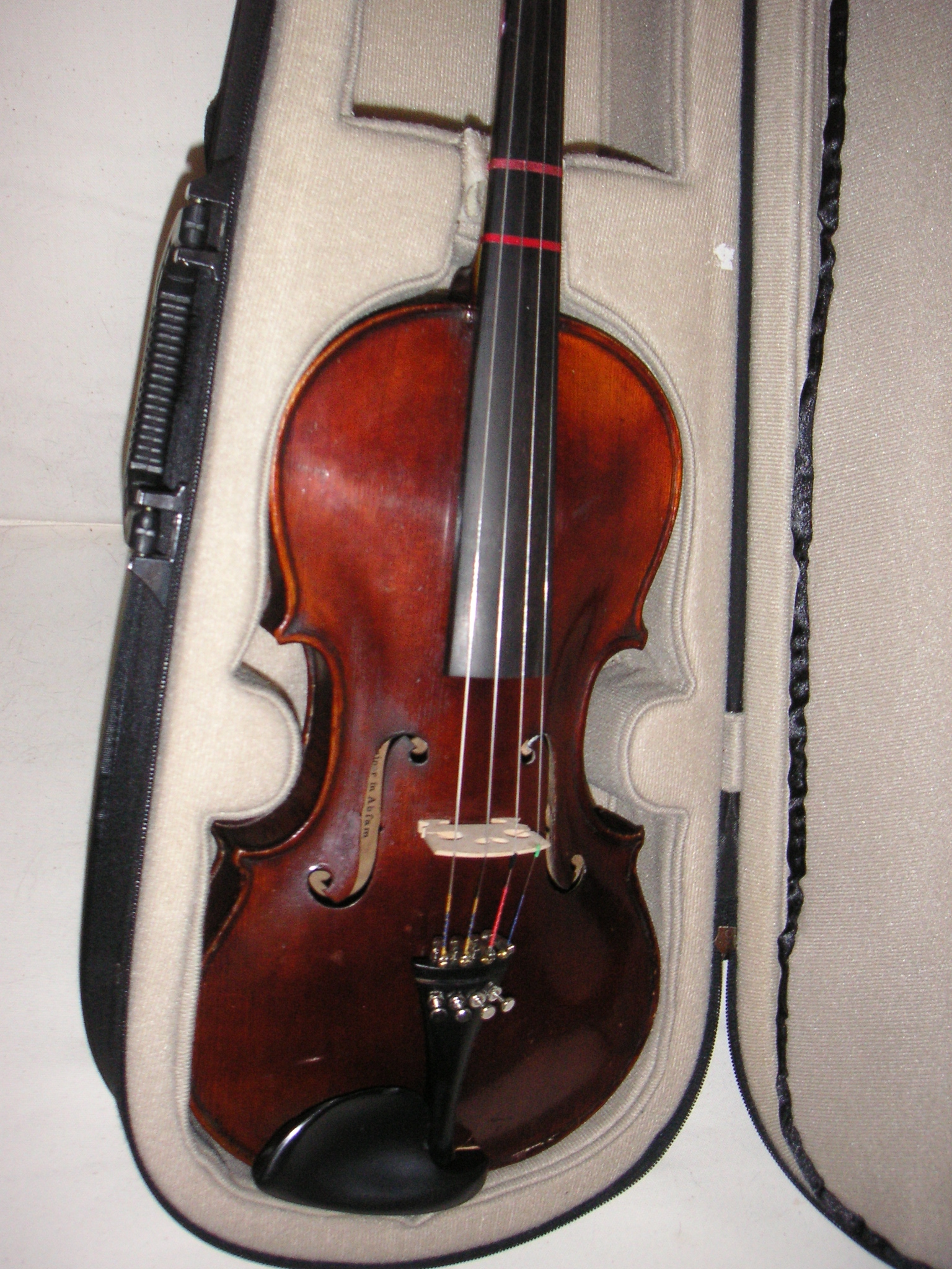 a violin in an orange case sitting open