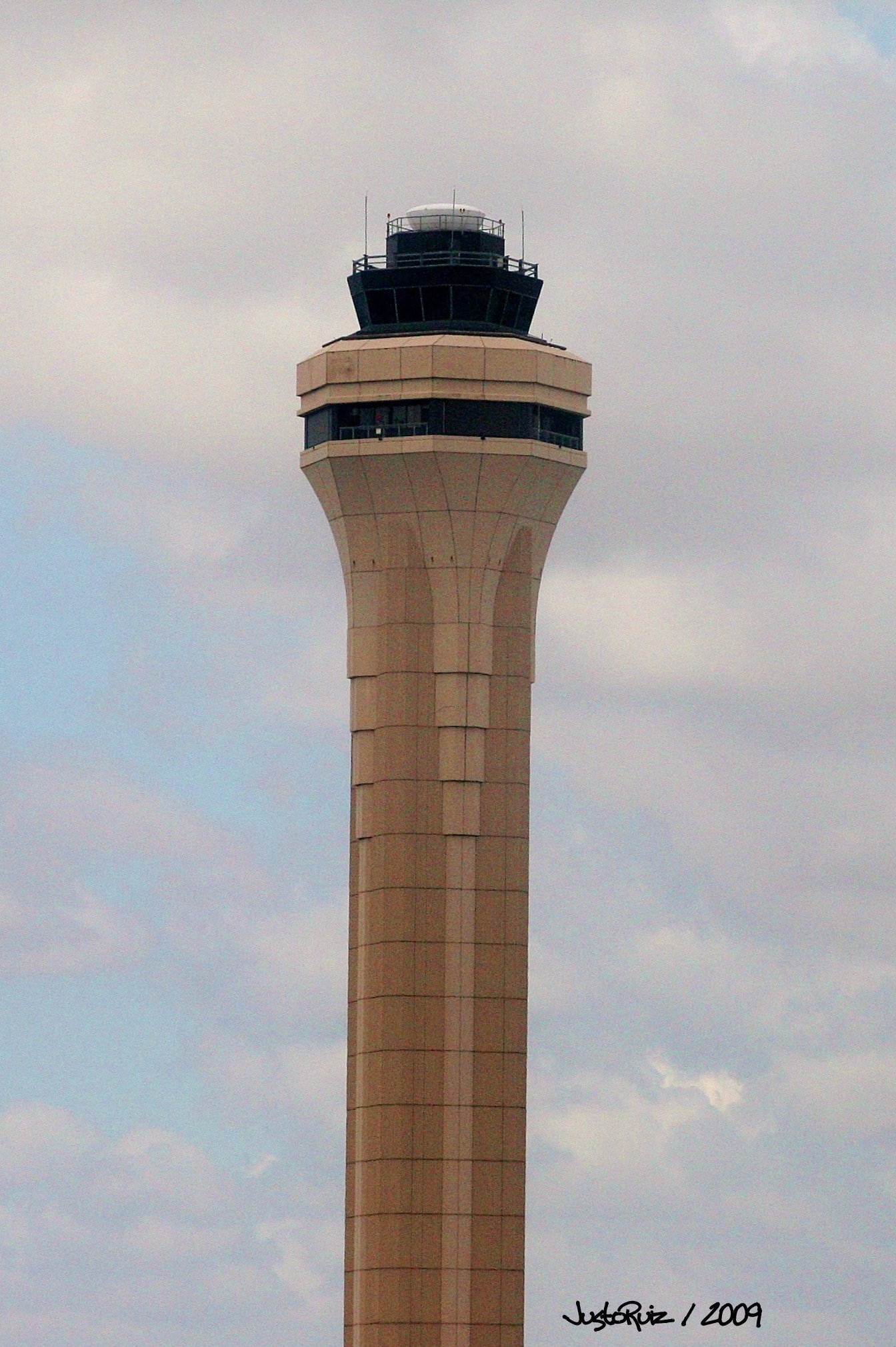 a tall tower sits high on a cloudy day