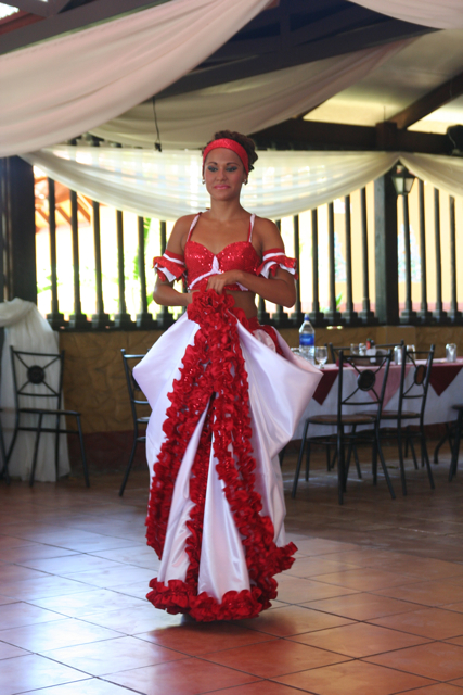 a woman is wearing red and white in a room