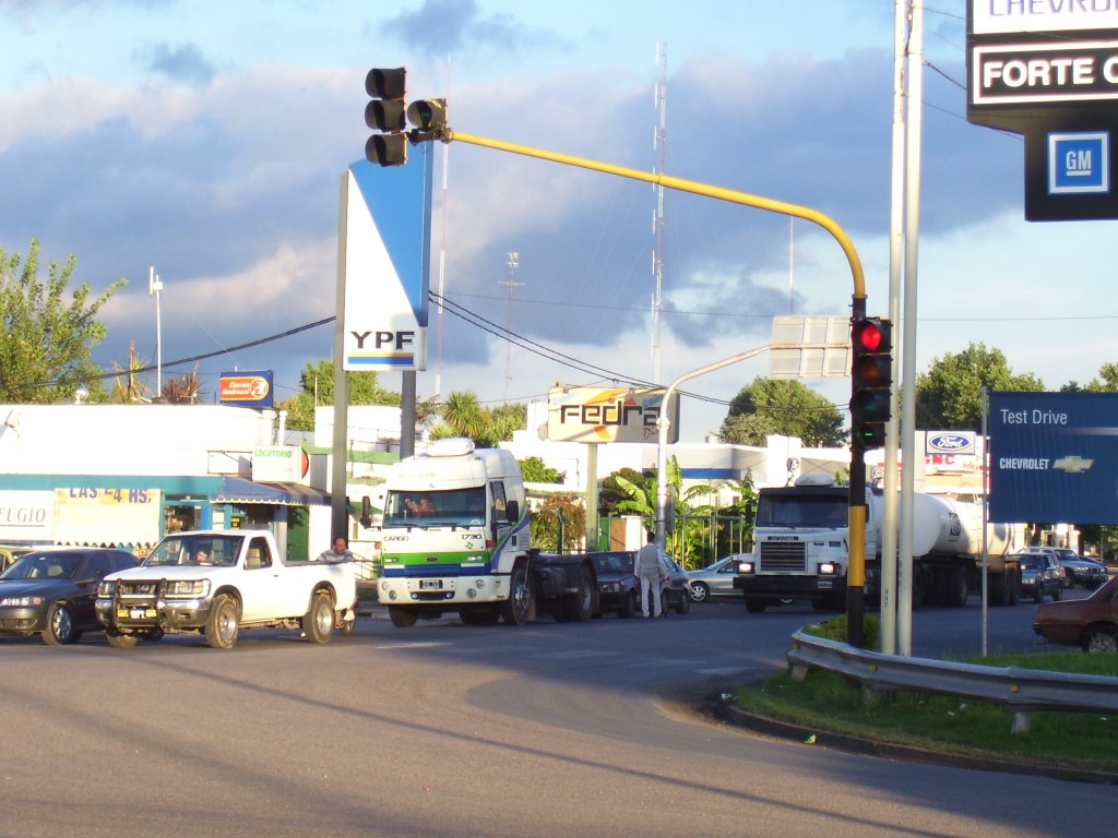 a couple of trucks are parked at a stop light