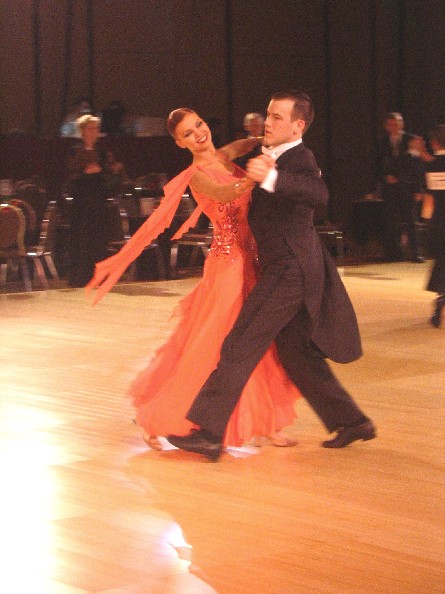 two people are dancing together in an auditorium