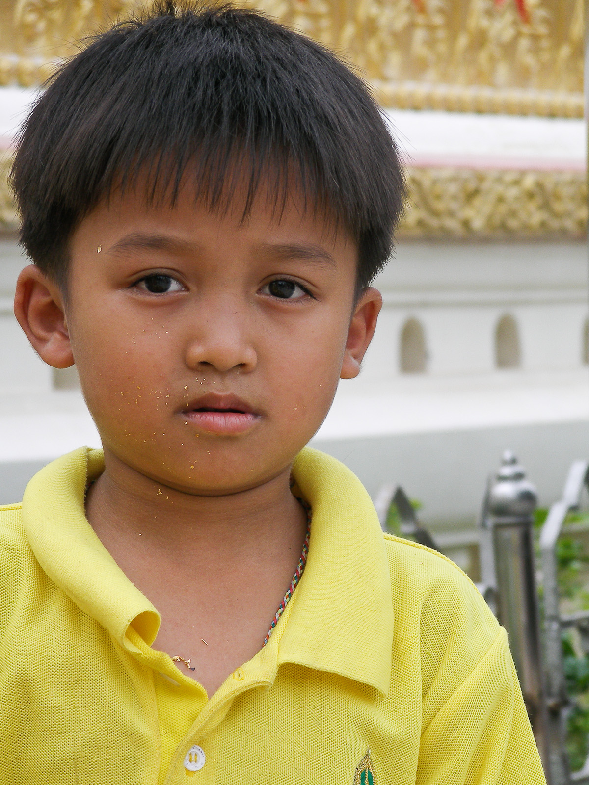 a close up of a child in yellow shirt