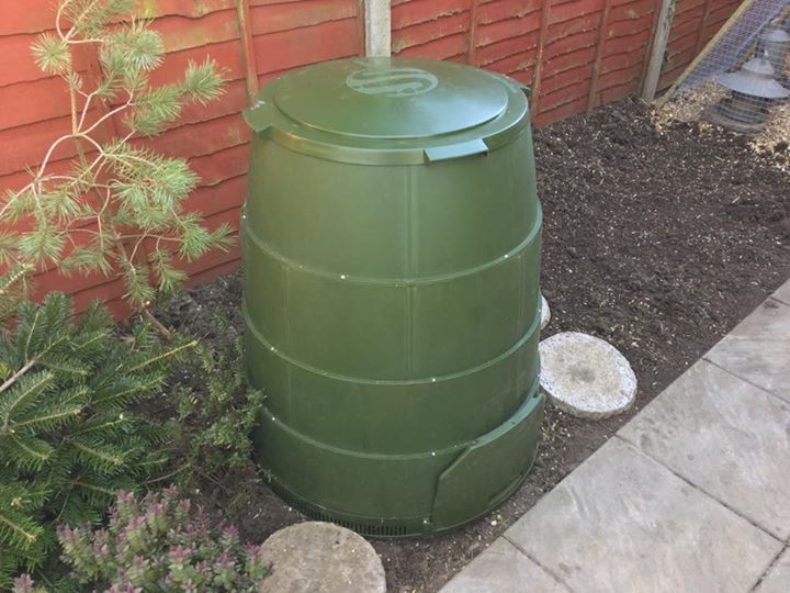 a barrel and landscaping near a building