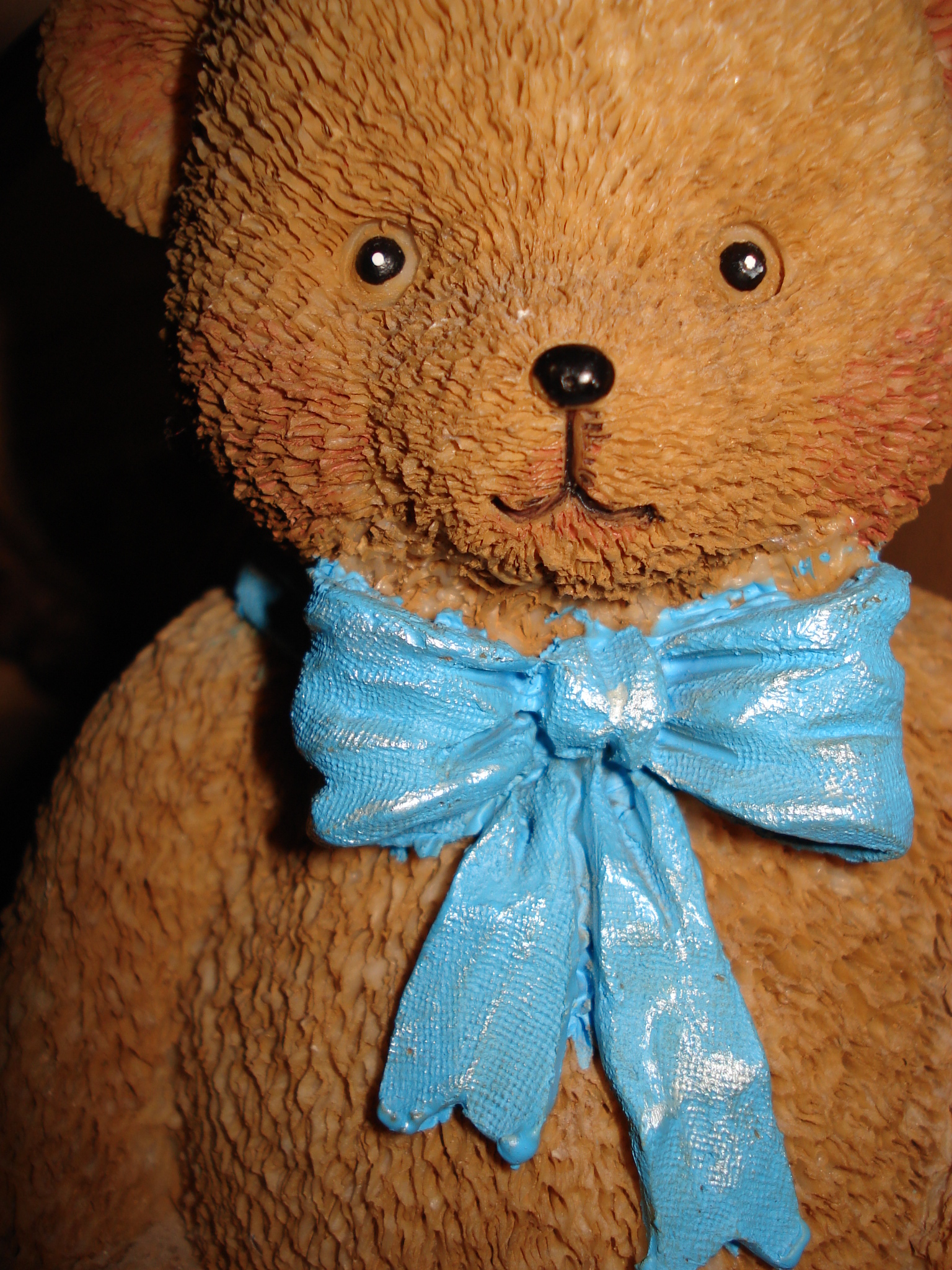 a small teddy bear wearing a blue bow